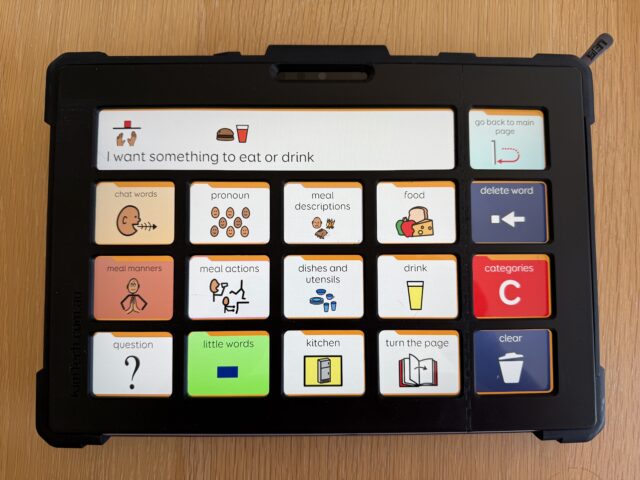 A Surface Pro tablet with Grid 3 PODD 15 grid set with a black keyguard fitted to the screen.