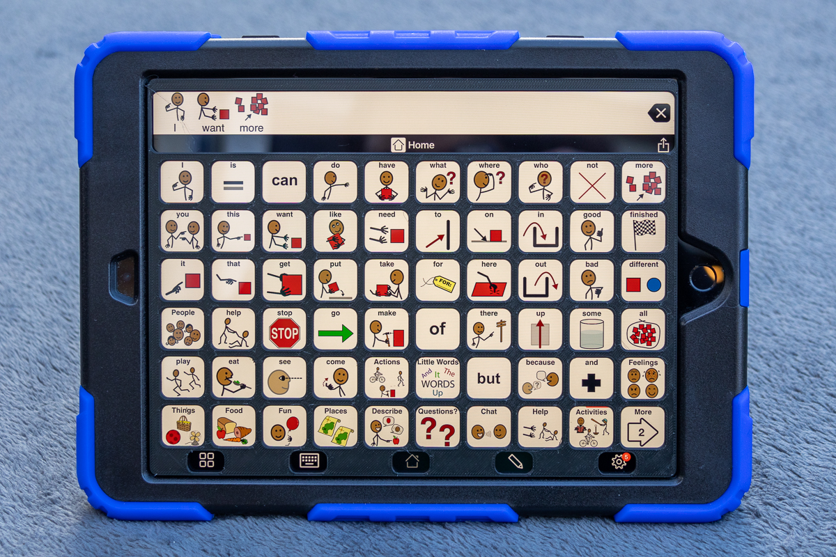 An iPad displaying Proloquo2go 6 by 10 grid layout with a 3D printed keyguard.