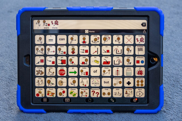 An iPad displaying Proloquo2go 6 by 10 page set with a 3D printed keyguard.