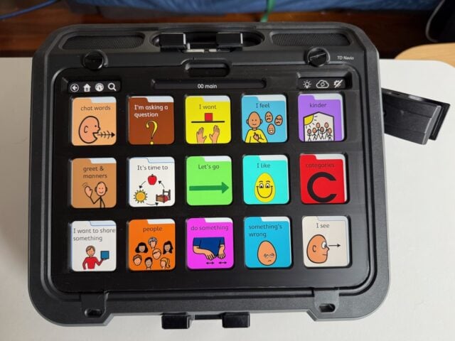 A Navio AAC device with TD Snap PODD 15 page set displayed with a black keyguard fitted.