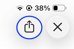 Close-up of iPad screen showing the share icon (square with upward arrow) highlighted next to a close (X) button and battery status.